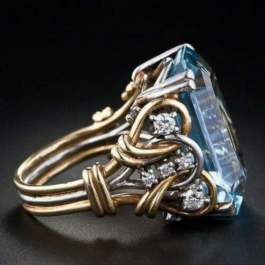 Vintage gold ring with layered design and blue cubic zirconia